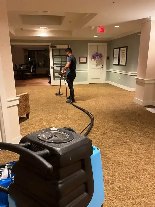 Technician steam cleaning basement carpet in New Castle, DE