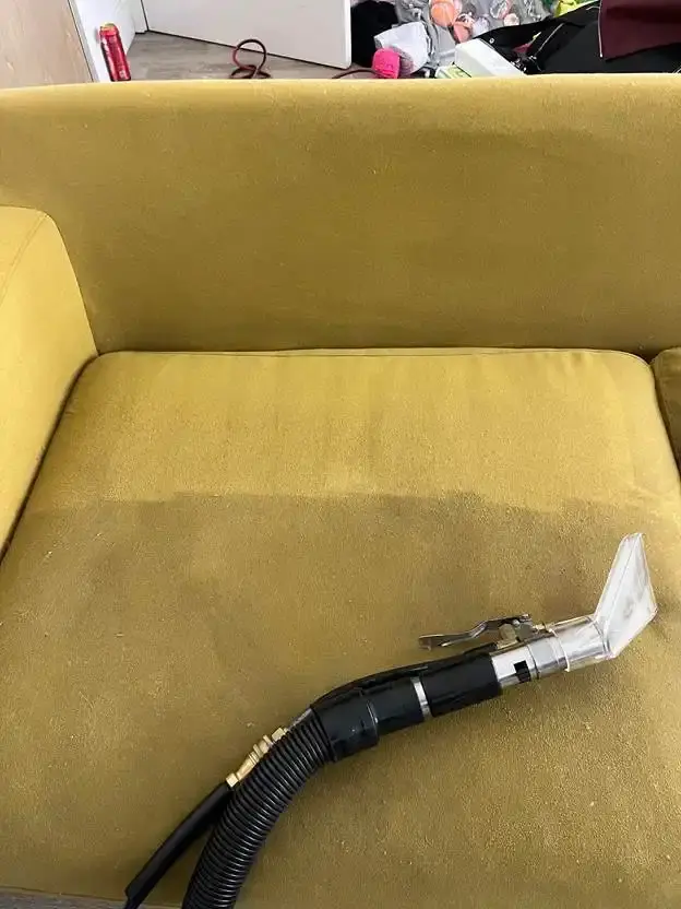 Before and after upholstery cleaning stripe on yellow sofa cushion
