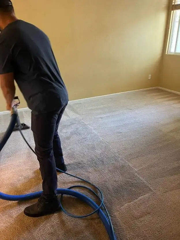 J&J technician carpet steam cleaning with truck-mount wand in Delaware
